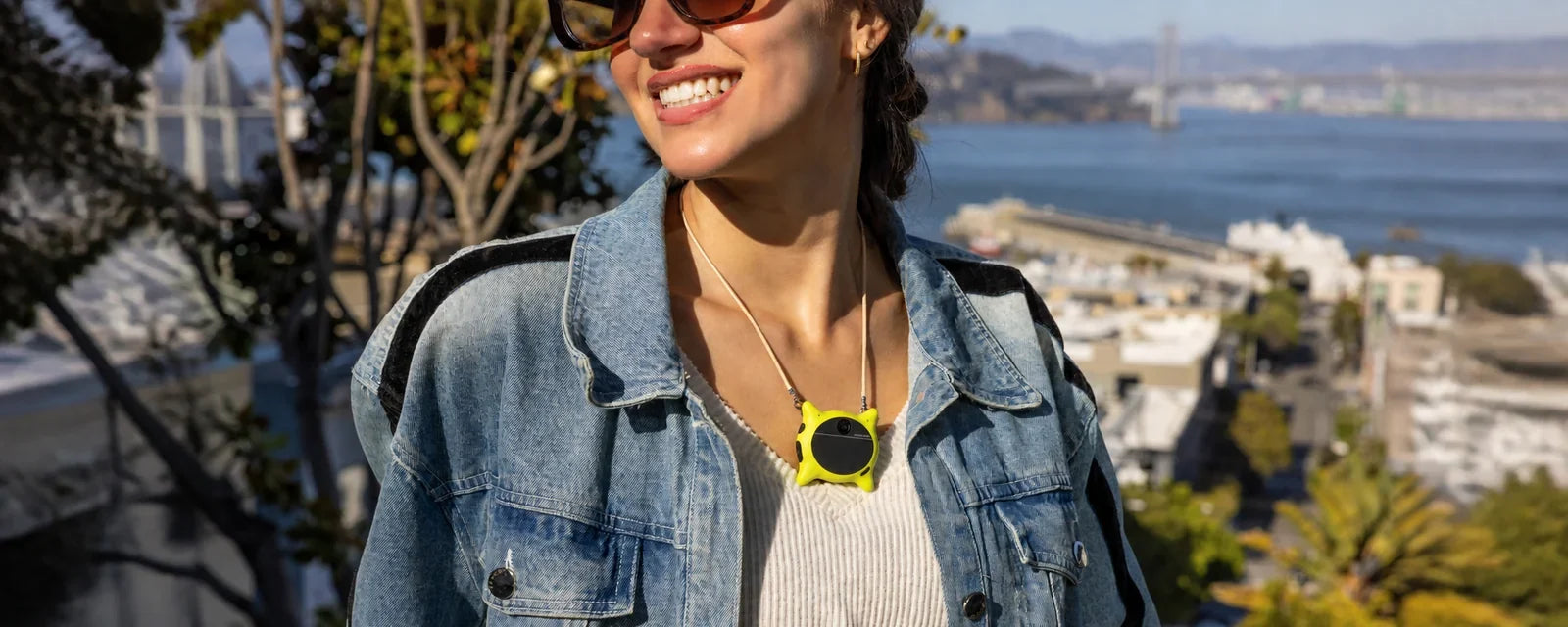 A person wearing the Looki L1 hands-free camera while outdoors.